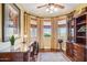 Inviting home office with custom built-ins, desk, and scenic backyard views at 18121 E San Luis Dr, Gold Canyon, AZ 85118