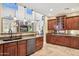 Spacious kitchen featuring granite countertops, stainless steel appliances, wood cabinets, and breakfast bar seating at 18121 E San Luis Dr, Gold Canyon, AZ 85118