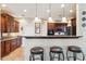 Stylish kitchen with granite countertops, tiled floors, a breakfast bar and stainless steel appliances at 18121 E San Luis Dr, Gold Canyon, AZ 85118