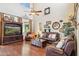 Cozy living room with a high ceiling, leather seating, ceiling fan, and entertainment center with a TV at 18121 E San Luis Dr, Gold Canyon, AZ 85118