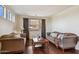 Comfortable living room features hardwood floors, couches, neutral walls, and bright, natural light at 18121 E San Luis Dr, Gold Canyon, AZ 85118