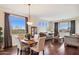 Living area with hardwood floors, a dining table, a large window with views, and a traditional chandelier at 18121 E San Luis Dr, Gold Canyon, AZ 85118