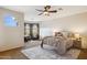 Spacious main bedroom with a ceiling fan and two lounge chairs for sitting at 18121 E San Luis Dr, Gold Canyon, AZ 85118