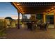 Inviting outdoor patio with a stone fireplace, comfortable seating, and warm lighting, perfect for entertaining guests at 18121 E San Luis Dr, Gold Canyon, AZ 85118