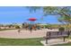 Community playground with slides, swings, and a covered picnic area, surrounded by greenery at 18121 E San Luis Dr, Gold Canyon, AZ 85118
