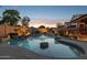Tranquil pool with accent lighting, unique rock formations, and a mature landscape, creating a private escape at 18121 E San Luis Dr, Gold Canyon, AZ 85118