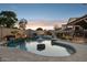 Inviting pool with rock accents, mature trees, and a cozy pergola, ideal for evening swims at 18121 E San Luis Dr, Gold Canyon, AZ 85118