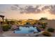 Stunning pool area with rock features, lush greenery, and desert views, creating a relaxing oasis at 18121 E San Luis Dr, Gold Canyon, AZ 85118