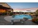 Gorgeous pool surrounded by desert landscaping, comfortable seating, and mountain views, perfect for entertaining at 18121 E San Luis Dr, Gold Canyon, AZ 85118