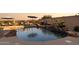 Beautiful backyard pool with rock waterfall feature and inviting lounge area at 18121 E San Luis Dr, Gold Canyon, AZ 85118