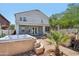 Relaxing backyard featuring a hot tub, covered patio, and lush landscaping at 19182 N Smith Dr, Maricopa, AZ 85139