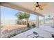 Covered patio looking out to a backyard with a hot tub and mature trees at 19182 N Smith Dr, Maricopa, AZ 85139