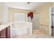 Bright bathroom featuring a soaking tub, glass-enclosed shower, and neutral decor at 19182 N Smith Dr, Maricopa, AZ 85139