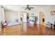 Bedroom boasts wood floors, neutral walls, and a ceiling fan with access to an attached bathroom and walk-in closet at 19182 N Smith Dr, Maricopa, AZ 85139