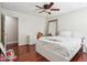 Bright bedroom features wood floors, ample light, a ceiling fan, closet, and en-suite bathroom at 19182 N Smith Dr, Maricopa, AZ 85139