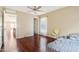 Bedroom with wood floors, neutral walls, ceiling fan and a large window bringing in natural light at 19182 N Smith Dr, Maricopa, AZ 85139