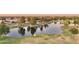 Community lake with water features, landscaping, and mature trees at 19182 N Smith Dr, Maricopa, AZ 85139