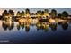 Community lake at twilight with trees, lighting, landscaping and reflections at 19182 N Smith Dr, Maricopa, AZ 85139