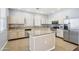 Well-lit kitchen featuring a center island, ample counter space, and stainless steel appliances at 19182 N Smith Dr, Maricopa, AZ 85139