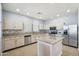 Modern kitchen with white cabinetry, granite countertops, an island and stainless-steel appliances at 19182 N Smith Dr, Maricopa, AZ 85139