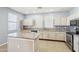 Well-lit kitchen boasting a center island, ample counter space, and stainless steel appliances at 19182 N Smith Dr, Maricopa, AZ 85139
