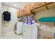 Laundry room with washer, dryer, overhead cabinets, and extra storage space at 19182 N Smith Dr, Maricopa, AZ 85139