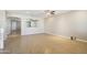Bright living room features an open layout and modern beige tile flooring at 19182 N Smith Dr, Maricopa, AZ 85139