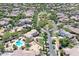 Bird's eye view of desert community featuring lush landscaping, pools, and community parks at 20409 W Thayer St, Buckeye, AZ 85396