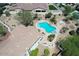 Aerial view of home featuring lush landscaping, pool/spa, seating areas, and desert aesthetics at 20409 W Thayer St, Buckeye, AZ 85396