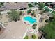 Aerial view of home featuring lush landscaping, pool/spa, seating areas, and desert aesthetics at 20409 W Thayer St, Buckeye, AZ 85396