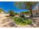 Expansive backyard featuring a putting green, lush landscaping, pool, and charming desert aesthetics at 20409 W Thayer St, Buckeye, AZ 85396