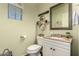 Powder room with decorative mirror, hexagon shelves and granite countertop vanity at 20409 W Thayer St, Buckeye, AZ 85396