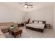 Well-lit bedroom featuring modern ceiling fan, cozy sitting area, and a comfortable bed setup for relaxation at 20409 W Thayer St, Buckeye, AZ 85396
