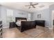 Primary bedroom boasts natural light, wood floors, ceiling fan and modern decor at 20409 W Thayer St, Buckeye, AZ 85396