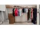 Walk-in closet with clothing racks, shelves, and storage boxes at 20409 W Thayer St, Buckeye, AZ 85396