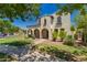 Inviting two-story home boasting arched entryways, manicured landscaping, and a well-maintained lawn, offering a welcoming curb appeal at 20409 W Thayer St, Buckeye, AZ 85396