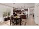 Eat-in kitchen features dark wood cabinets, stainless steel appliances, and a breakfast nook at 20409 W Thayer St, Buckeye, AZ 85396