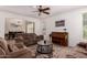 Cozy living room with comfortable sofas, a ceiling fan, and wood-look floors, creating a relaxing and inviting atmosphere at 20409 W Thayer St, Buckeye, AZ 85396