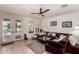 Bright living room featuring a large sectional sofa, tile flooring, and a view of the outdoor space at 20409 W Thayer St, Buckeye, AZ 85396