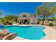 Resort-style backyard pool and spa with desert landscaping, patio, and outdoor kitchen at 20409 W Thayer St, Buckeye, AZ 85396