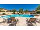 Relaxing backyard pool area with lounge chairs and lush landscaping at 20409 W Thayer St, Buckeye, AZ 85396