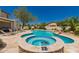 Inviting backyard pool with a spa, desert landscaping, and rock waterfall feature at 20409 W Thayer St, Buckeye, AZ 85396