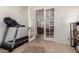 View through glass doors to living room from room with a treadmill at 20409 W Thayer St, Buckeye, AZ 85396