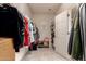 Bright walk-in closet with ample hanging space, shelving, and tiled flooring, perfect for organized storage at 20409 W Thayer St, Buckeye, AZ 85396