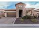 Charming brick home featuring a two-car garage and inviting front entrance at 2065 N Red Clf, Mesa, AZ 85207