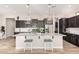Spacious kitchen with a large island, pendant lighting, and stainless steel appliances at 2065 N Red Clf, Mesa, AZ 85207