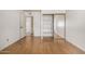 Empty bedroom features hardwood floors, white walls and a mirrored closet at 2119 E Sesame St, Tempe, AZ 85283