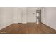 A bedroom featuring light hardwood floors, white walls, and a doorway leading to another room at 2119 E Sesame St, Tempe, AZ 85283