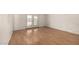 A bedroom with laminate flooring and double doors leading to the backyard; primed for your updates at 2119 E Sesame St, Tempe, AZ 85283
