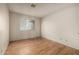 A bedroom features hardwood floors, white walls and a window with blinds allowing natural light at 2119 E Sesame St, Tempe, AZ 85283
